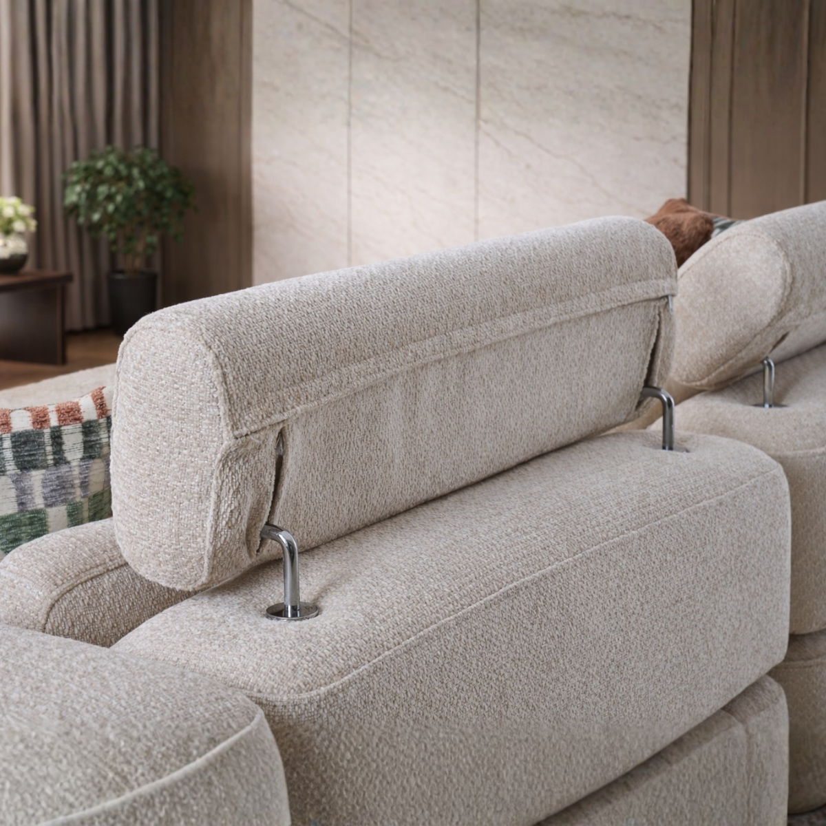 Gray sectional sofa with decorative pillows in a modern living room setting.